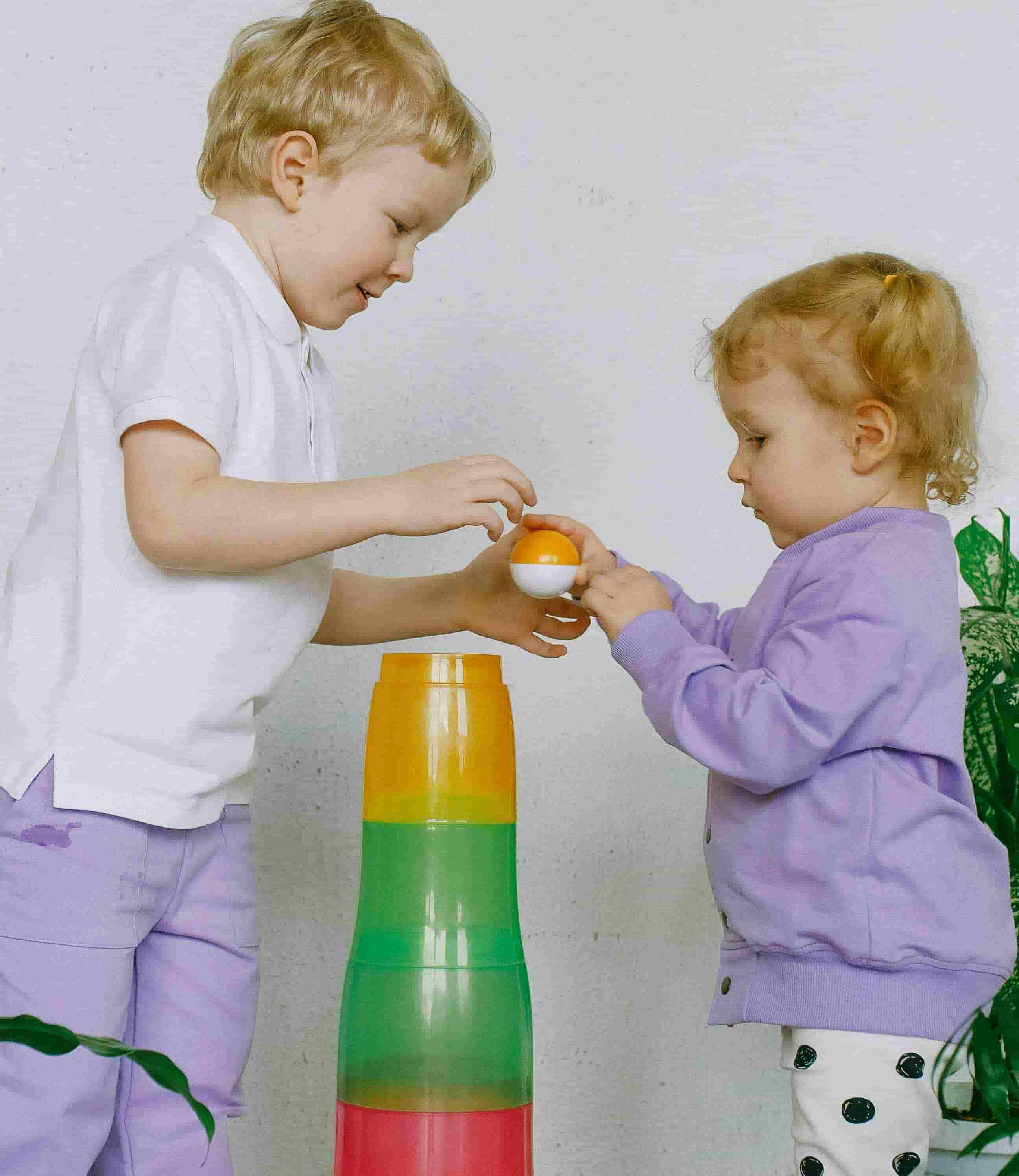 Front of zip tote bag with white canvas, black canvas straps and handle, and black zipper pulls.