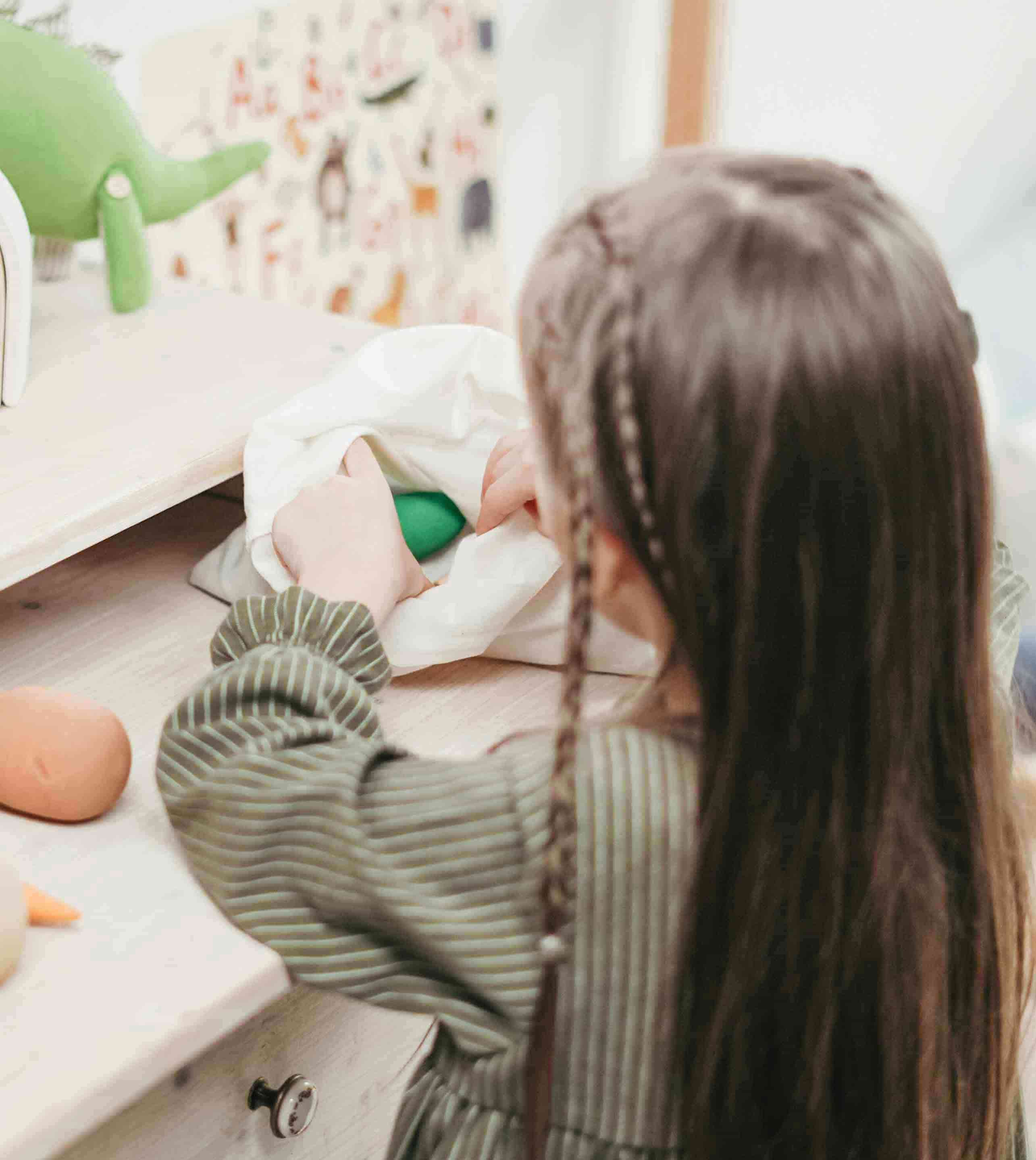 Front of zip tote bag with white canvas, black canvas straps and handle, and black zipper pulls.