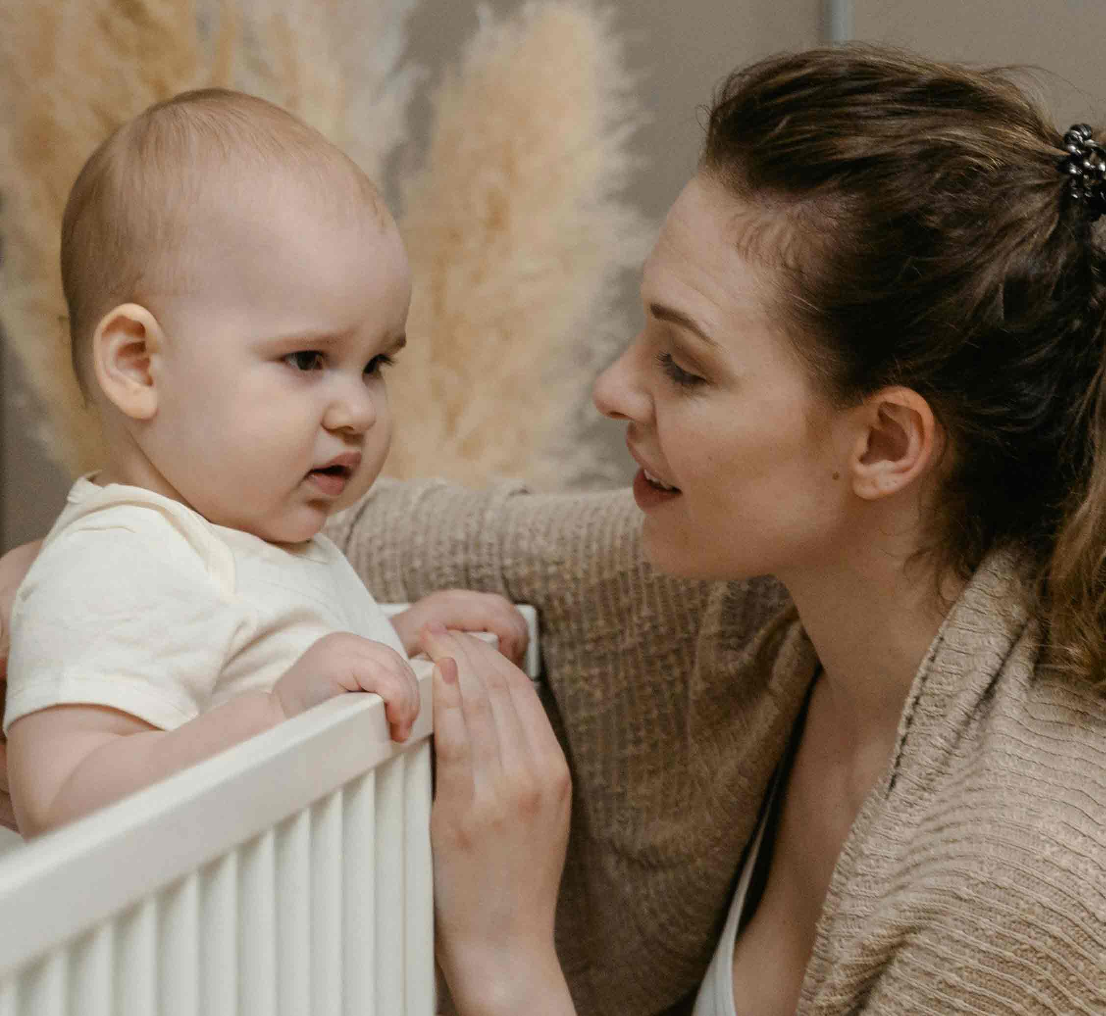 Front of zip tote bag with white canvas, black canvas straps and handle, and black zipper pulls.